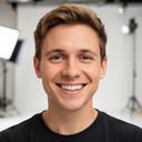 Portrait of Taslim Felthouse smiling in a bright studio setting